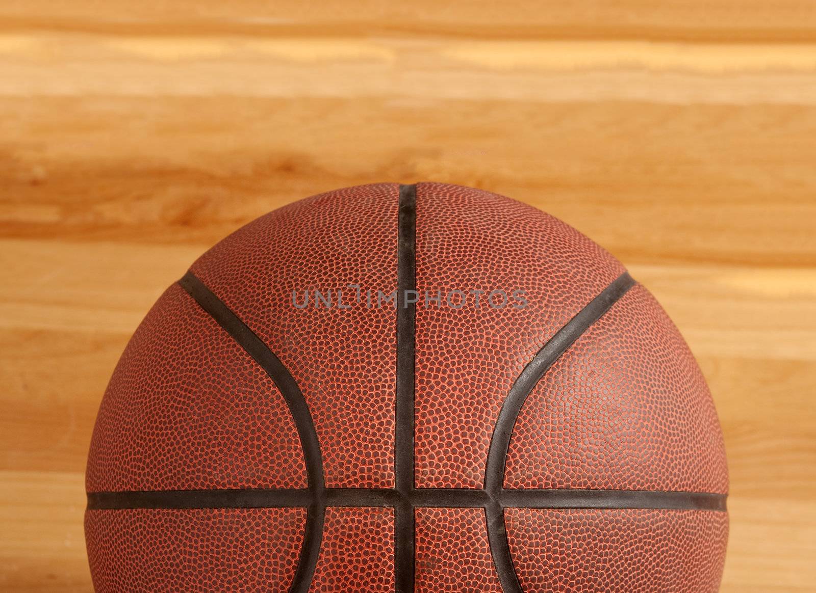 Basketball on floor of hard wood court 