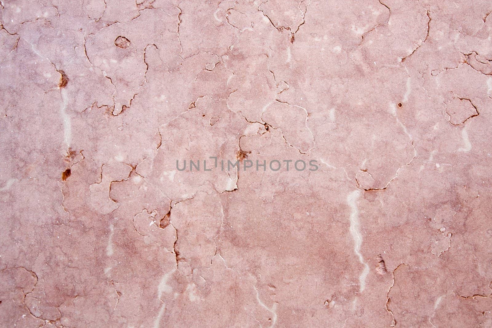 Close view of a pink textured marble wall.