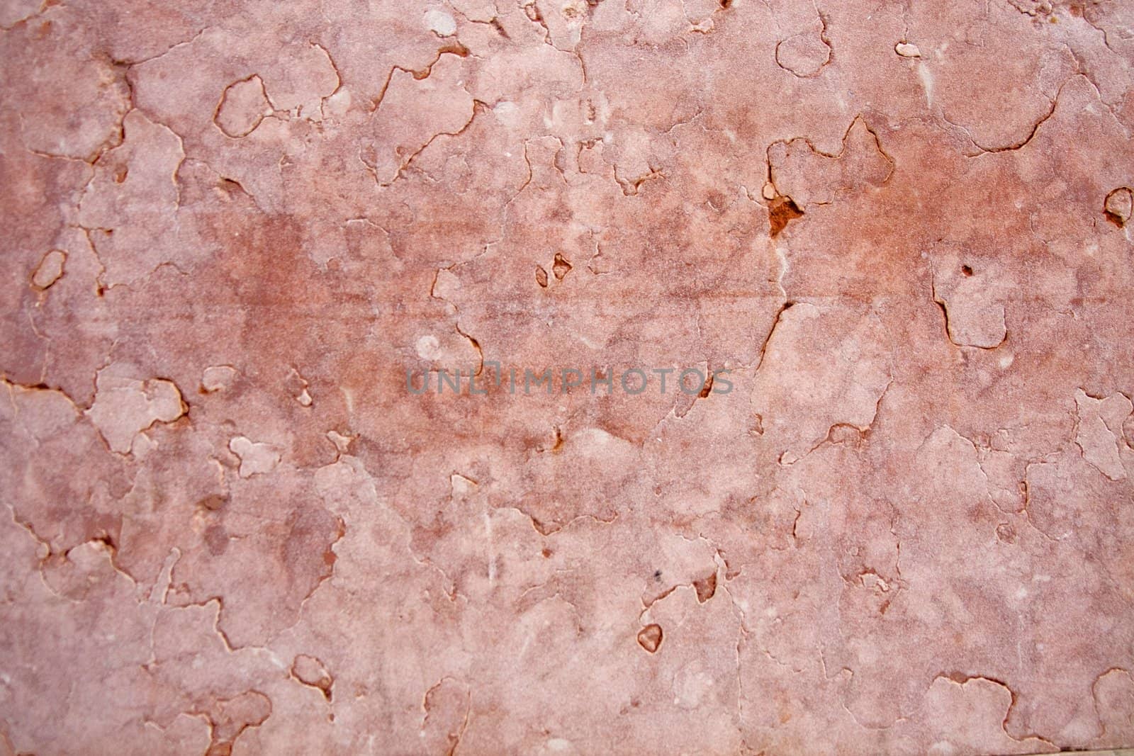 Close view of a pink textured marble wall.
