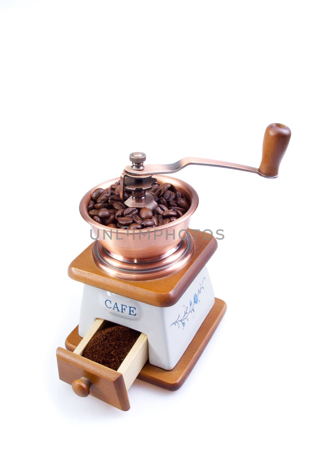 The ancient coffee grinder with coffee grains