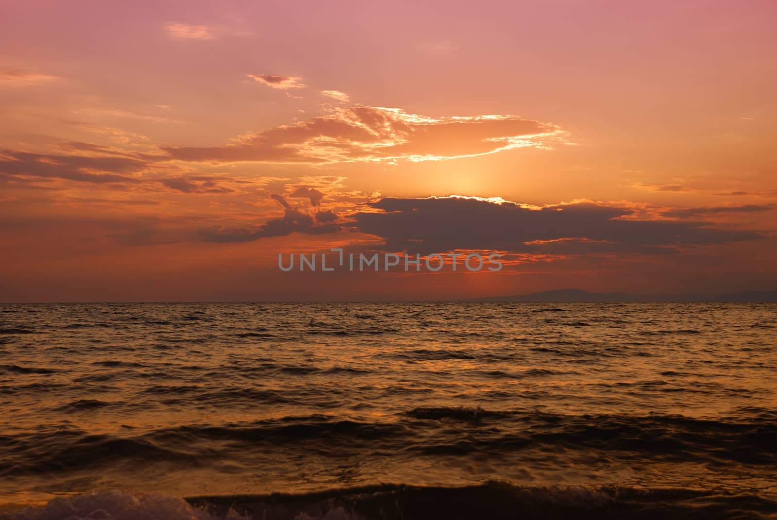 Orange and pink twilight over Paradisos beach in Sithonia, Halkidiki, Greece.