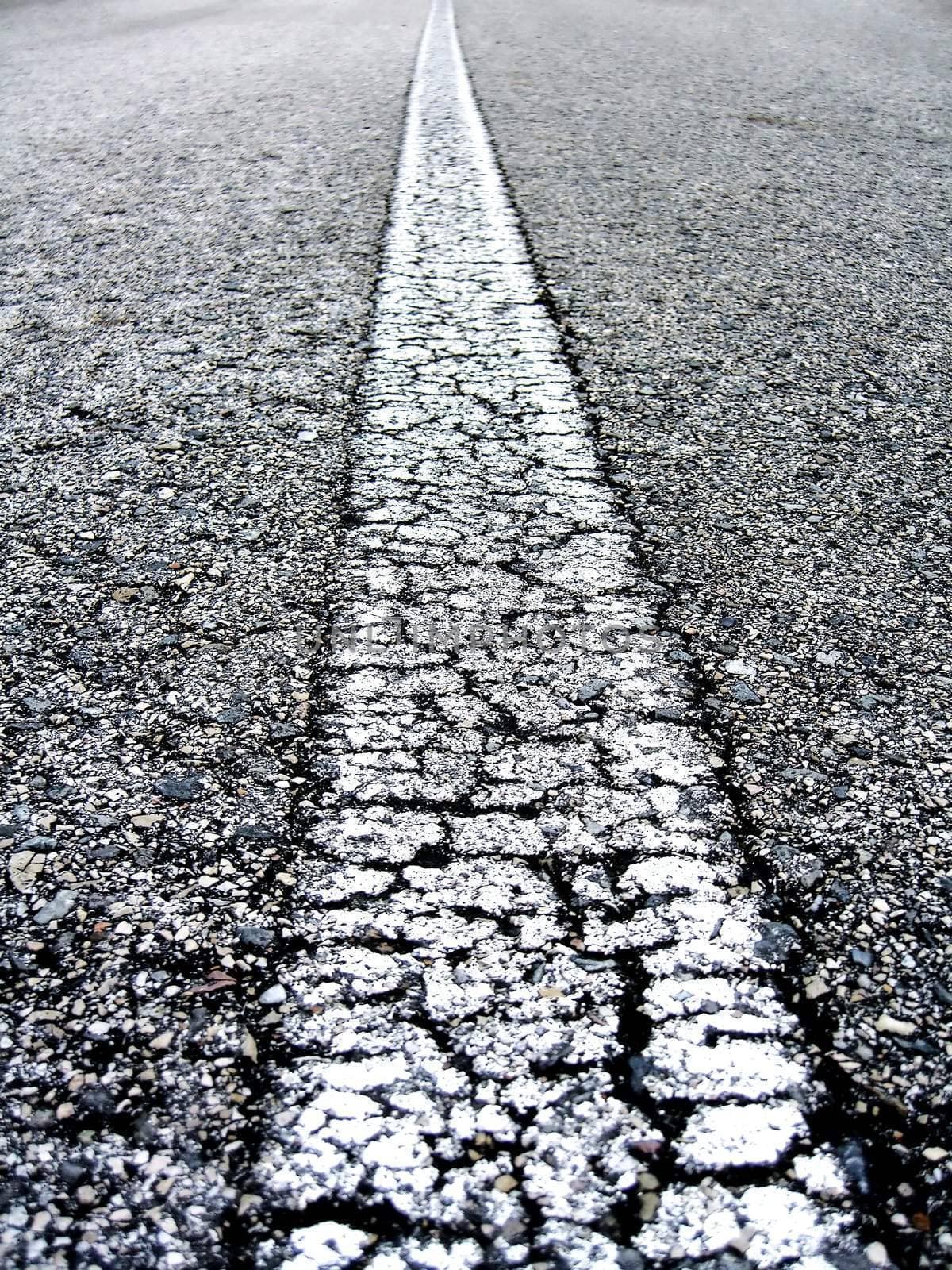 Close-up on the white line of an alphast road.