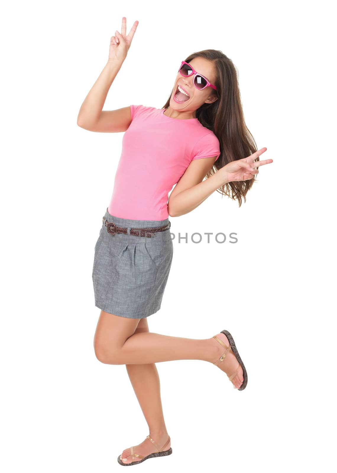 Funny woman dancing showing victory hand sign wearing cheap red sunglasses. Asian / Caucasian model isolated on white background in full length. 