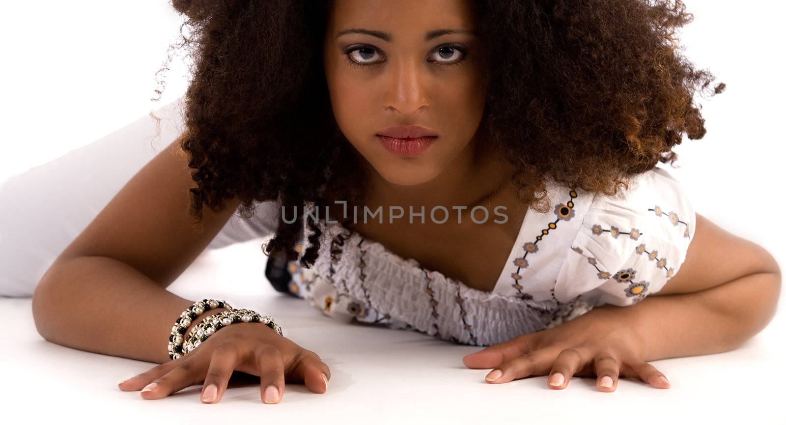 Young african girl is crawling to the lens