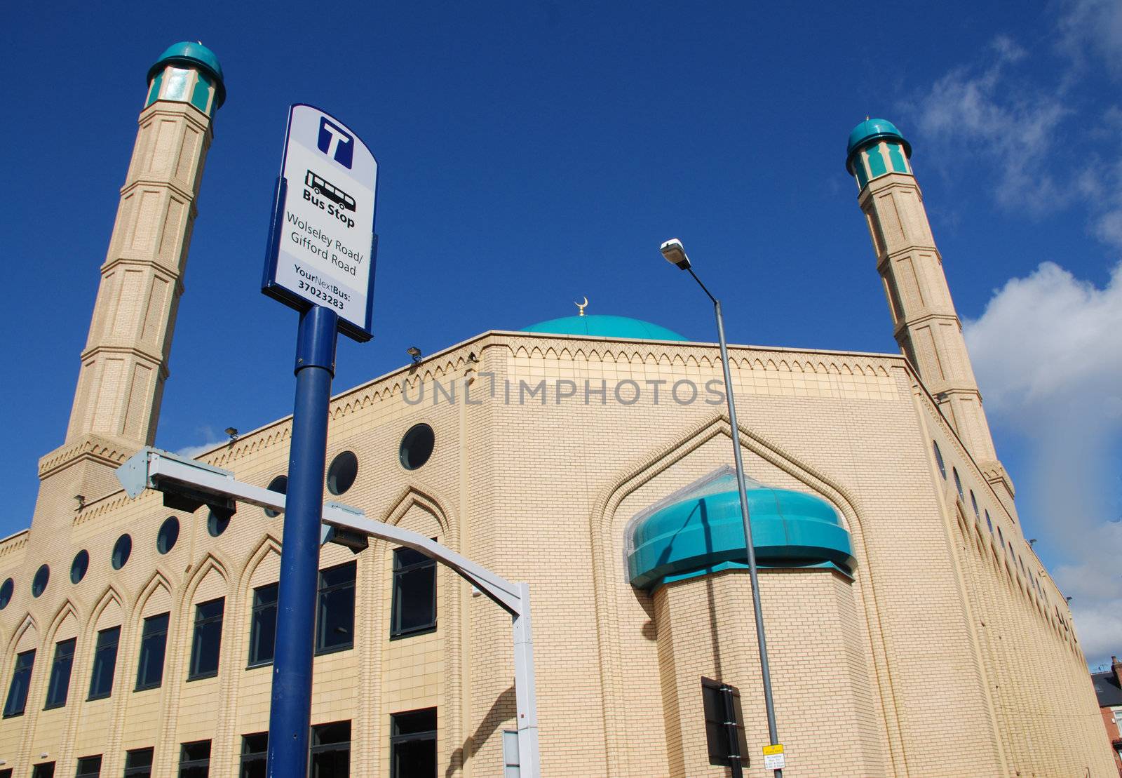 A photograph of a Mosque in Sheffield, a northern English city, next to a bus stop.