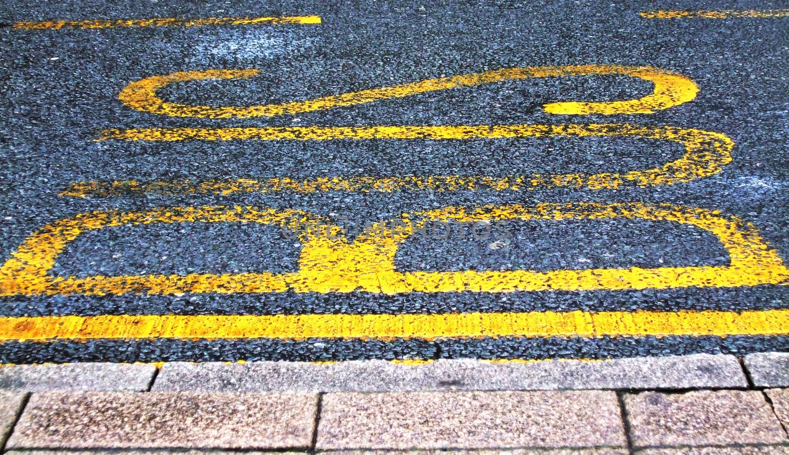 BUS painted onto road tarmac to signal a bus stop