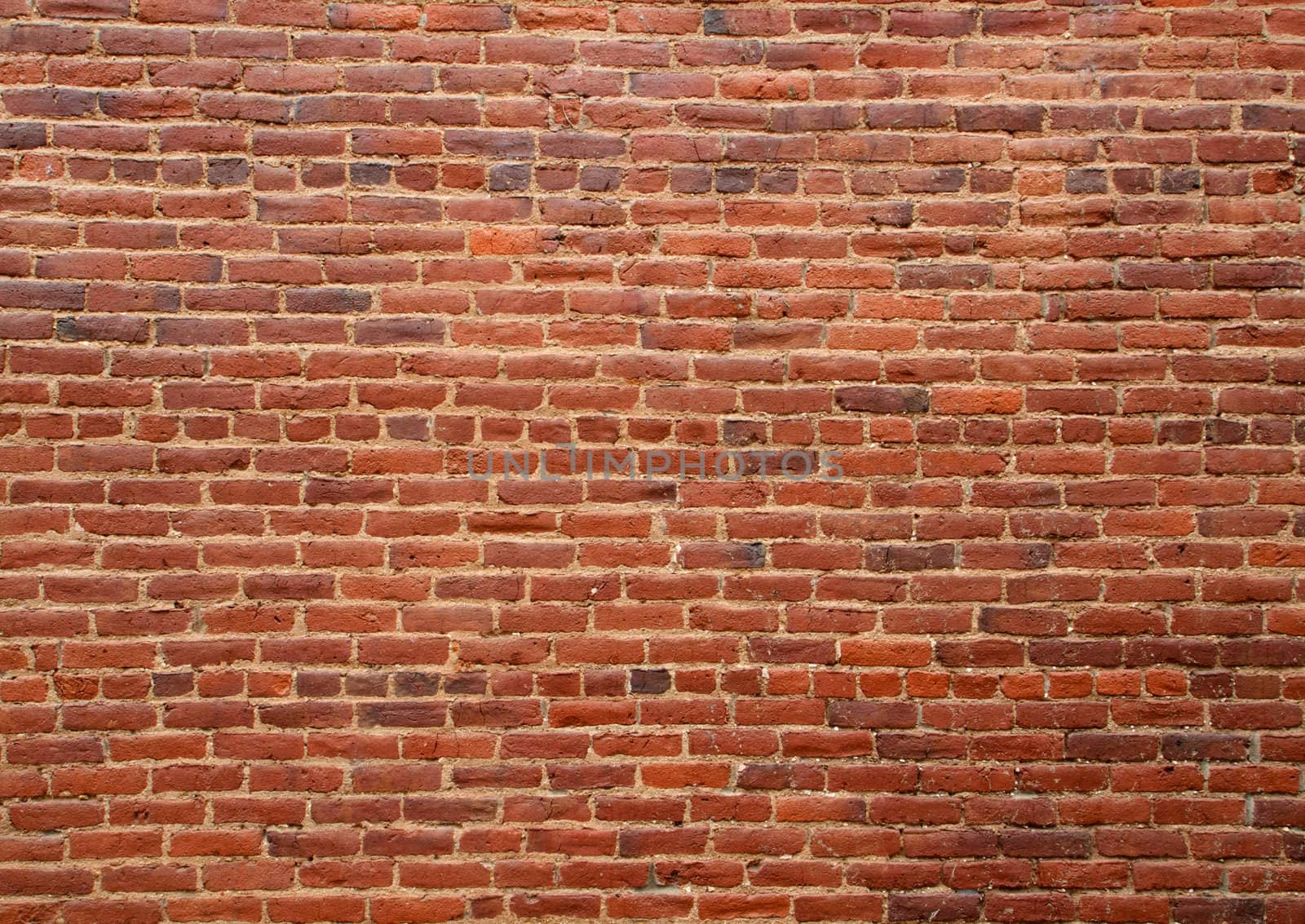 Old dirty multi shaded red brick wall 