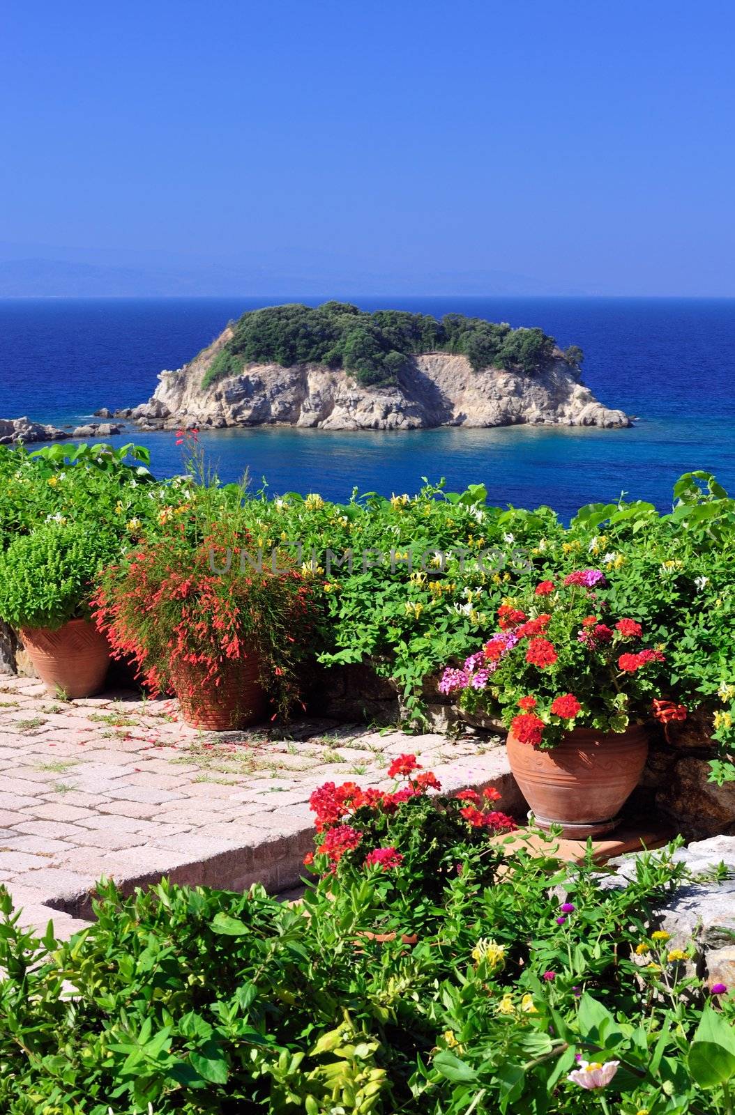 Detail of a garden veranda with a spectacular view overlooking a small island in the Aegean Sea