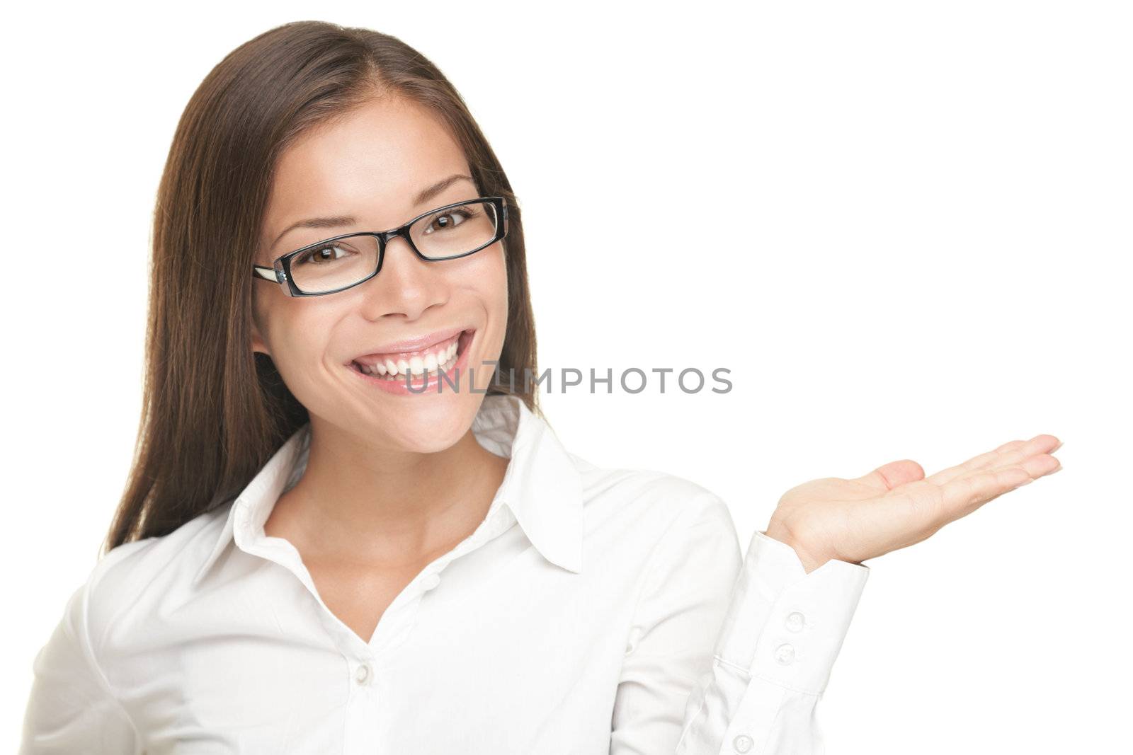Woman showing copy space for product with open hand palm - smiling friendly expression on young businesswoman wearing glasses, Isolated on white background. Mixed Asian / Caucasian model. 