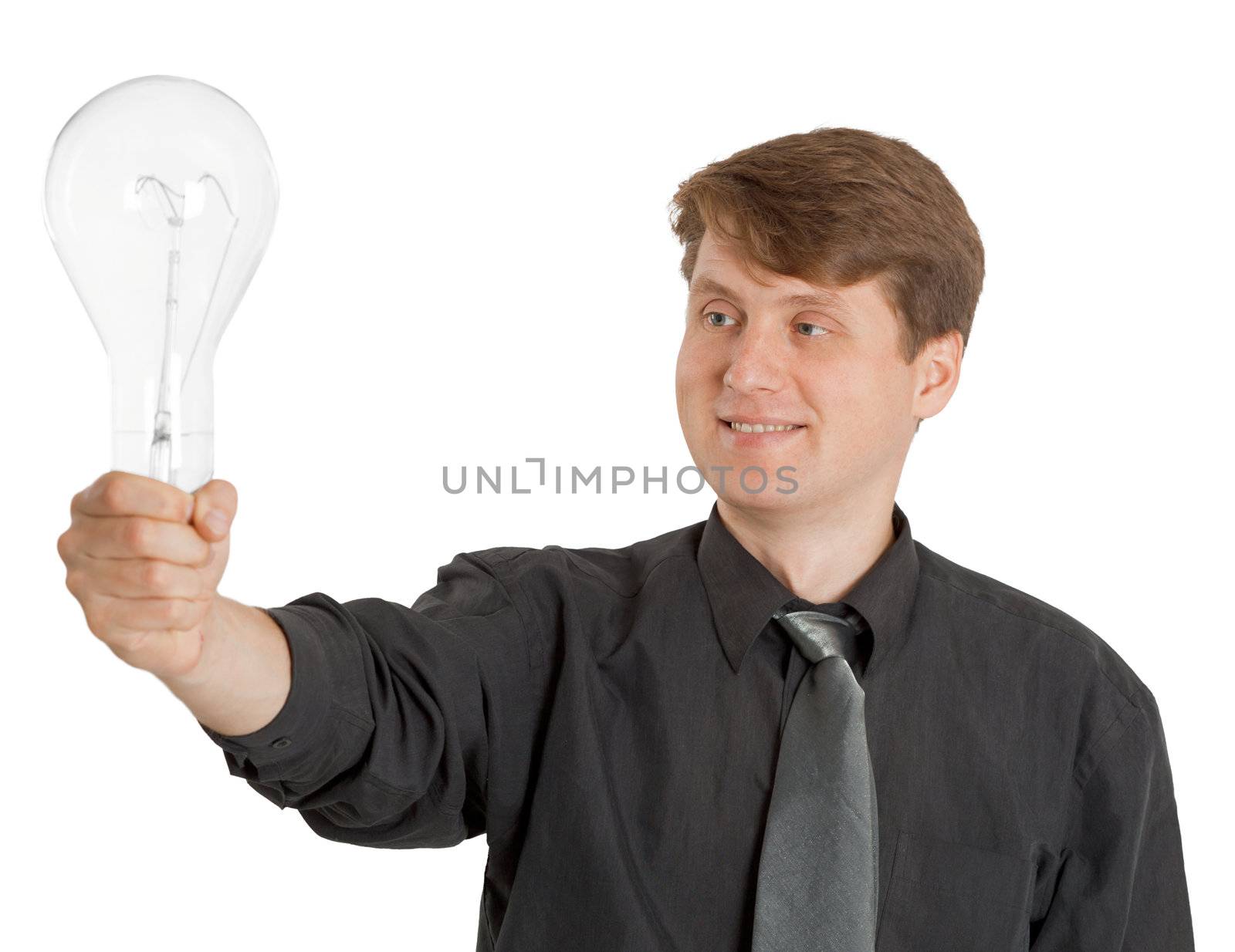 Satisfied man holding a large light bulb on white