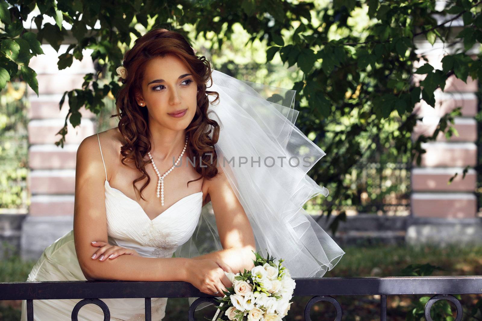 The beautiful bride on a green background