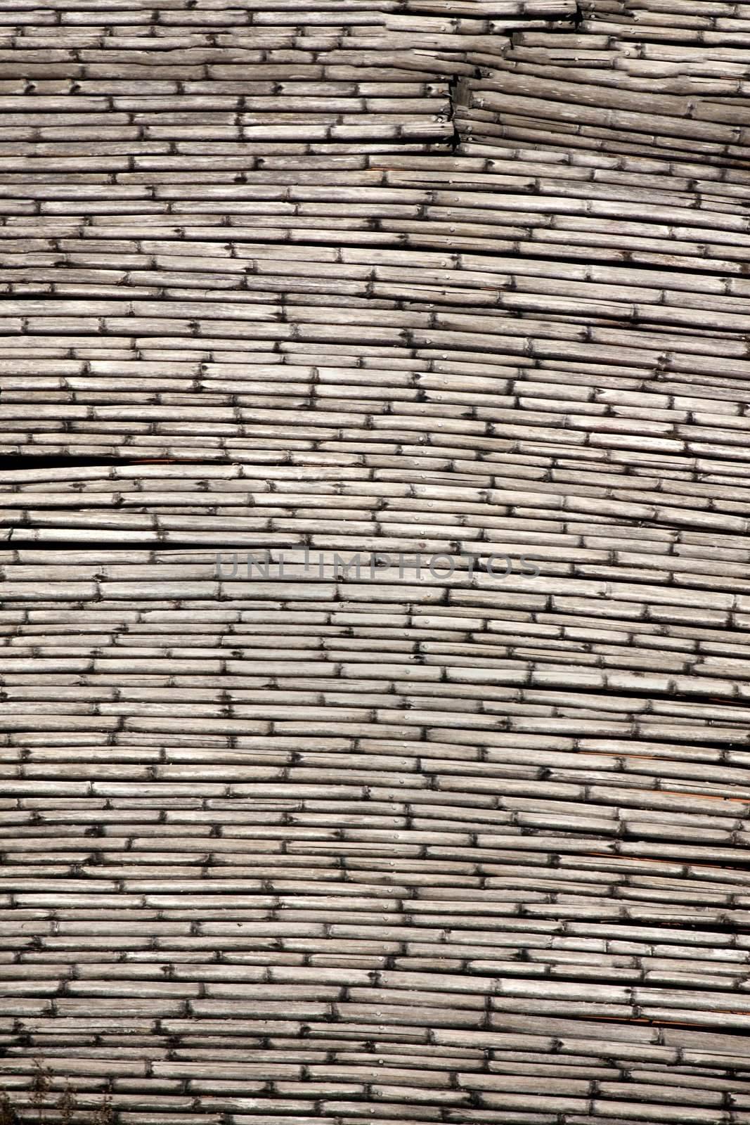 Close view of a dry bamboo wall .