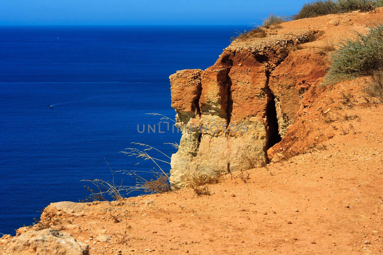 cap at Algarve, rocks and blue sea