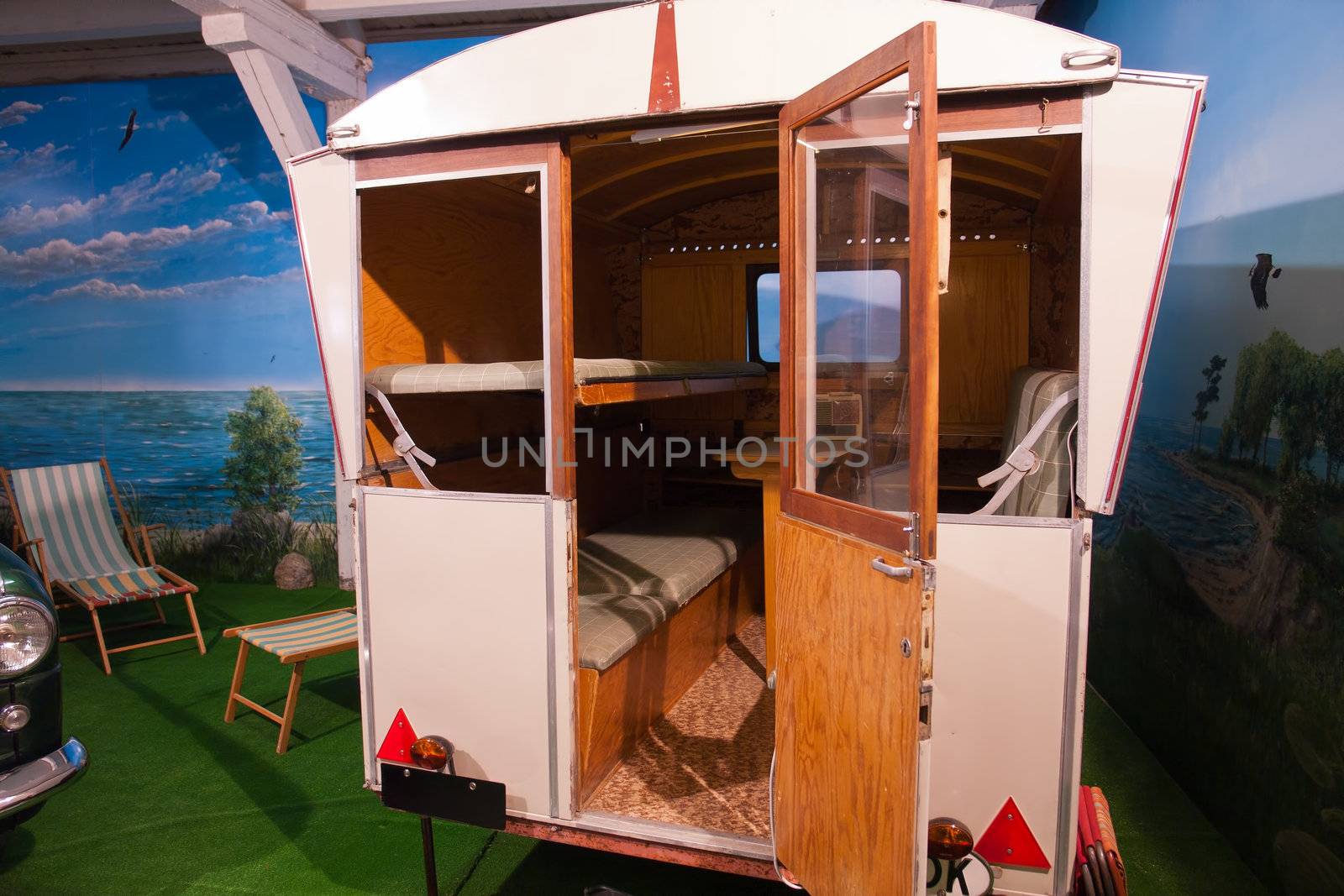 Vintage classical 50s 60s retro camper caravan with an armchair
