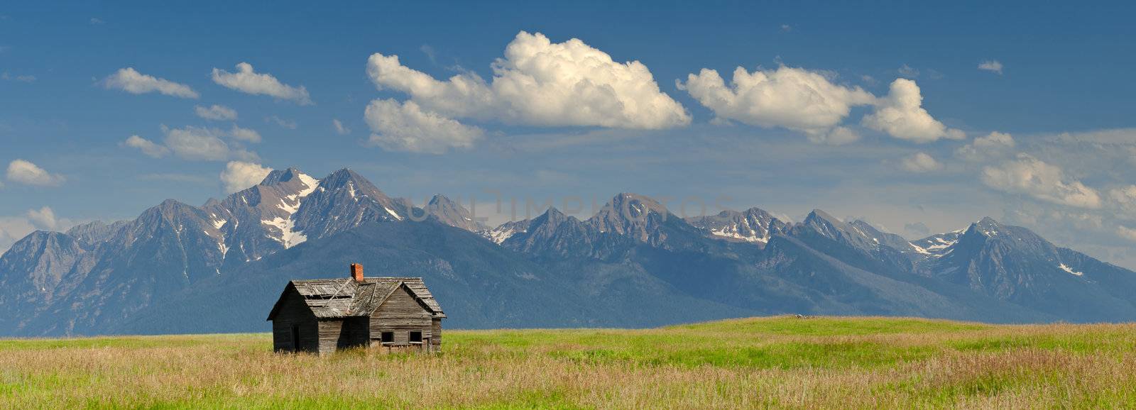 Panorama of an abandoned cabin and the Mission Mountains, Lake County, Montana, USA