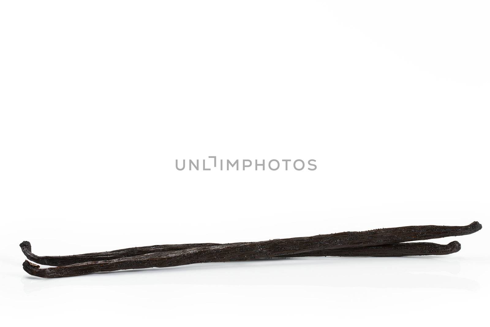 two vanilla beans from side on white background