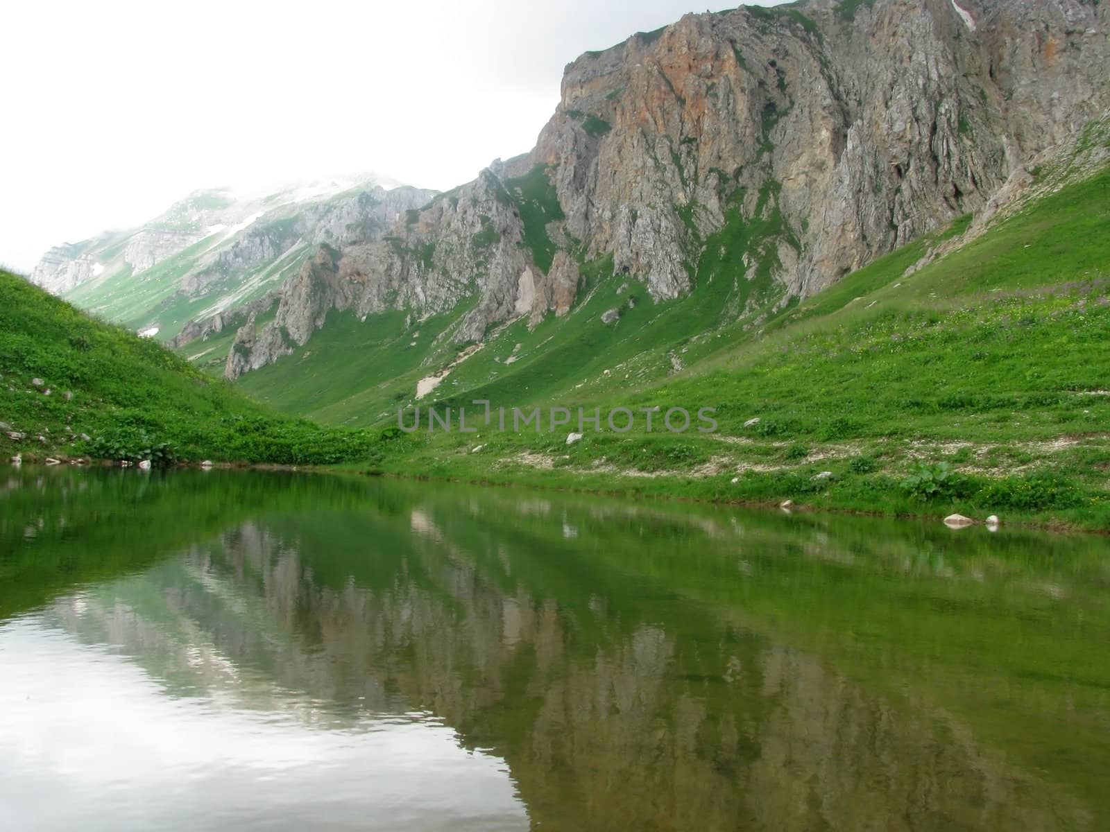 Mountains, rocks; a relief; a landscape; a hill; a panorama; Caucasus; top; lake, water, reflection, a slope; a snow
