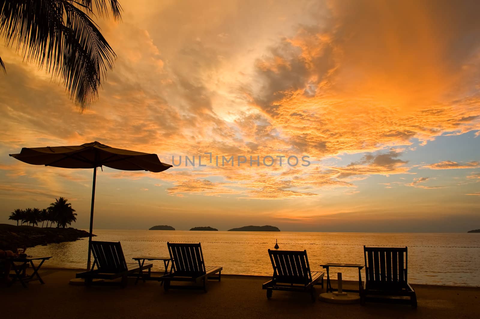 Silhouette of two relaxing seats at seashore