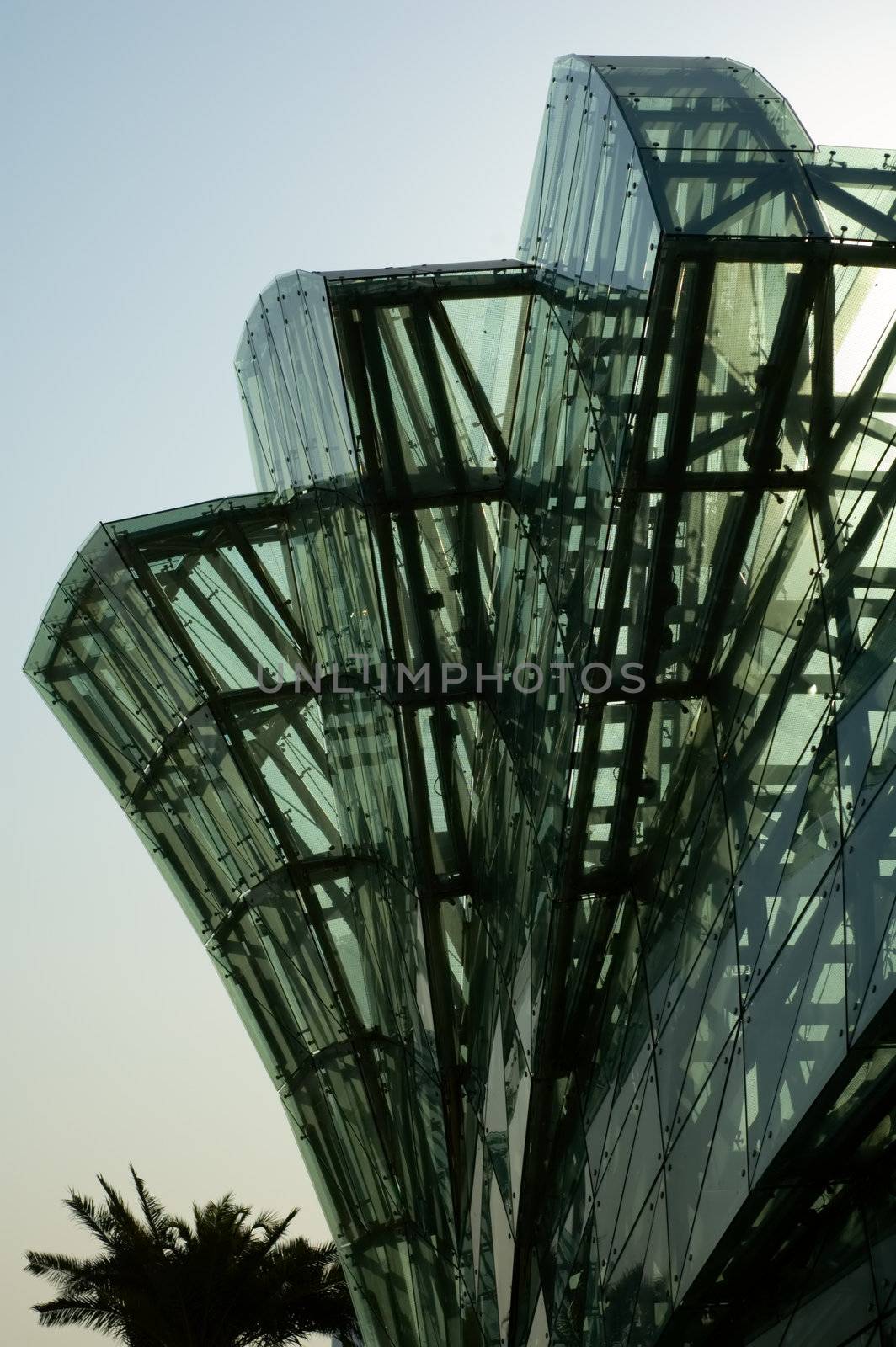 Abstract green glass of petals of lotus shaped architecture over sunshine