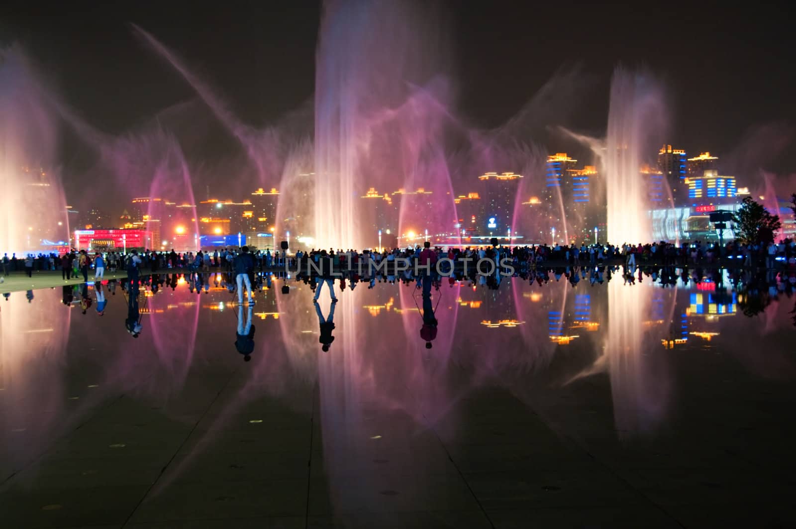 SHANGHAI - MAY 24: Reflection of fountain show over water. May 24, 2010 in Shanghai China. 