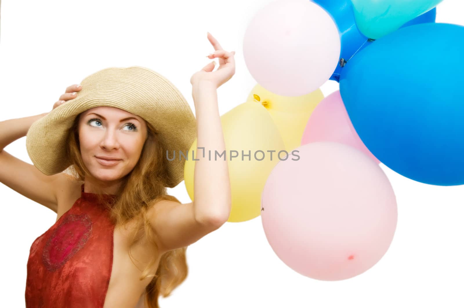 Smiling woman in hat with bunch of balloons over white