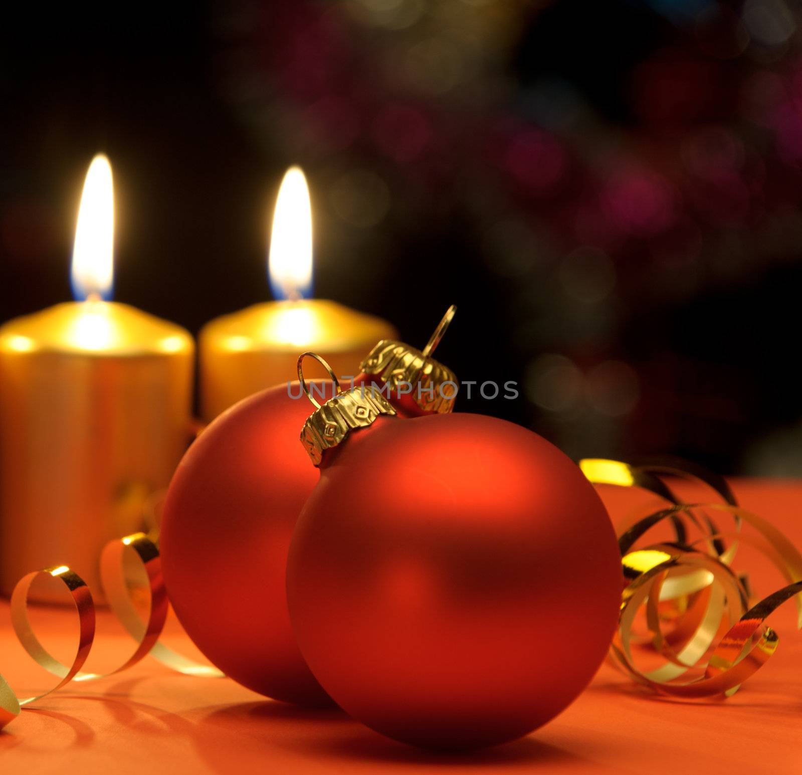 Christmas candles and red spheres. A celebratory composition