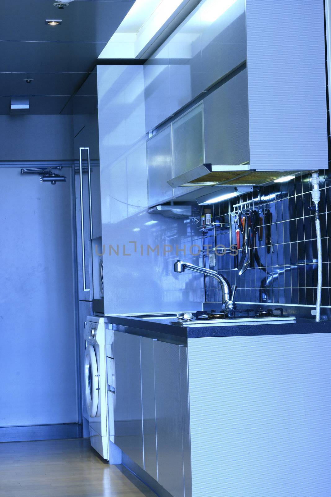 Modern kitchen with chrome faucet and fridge