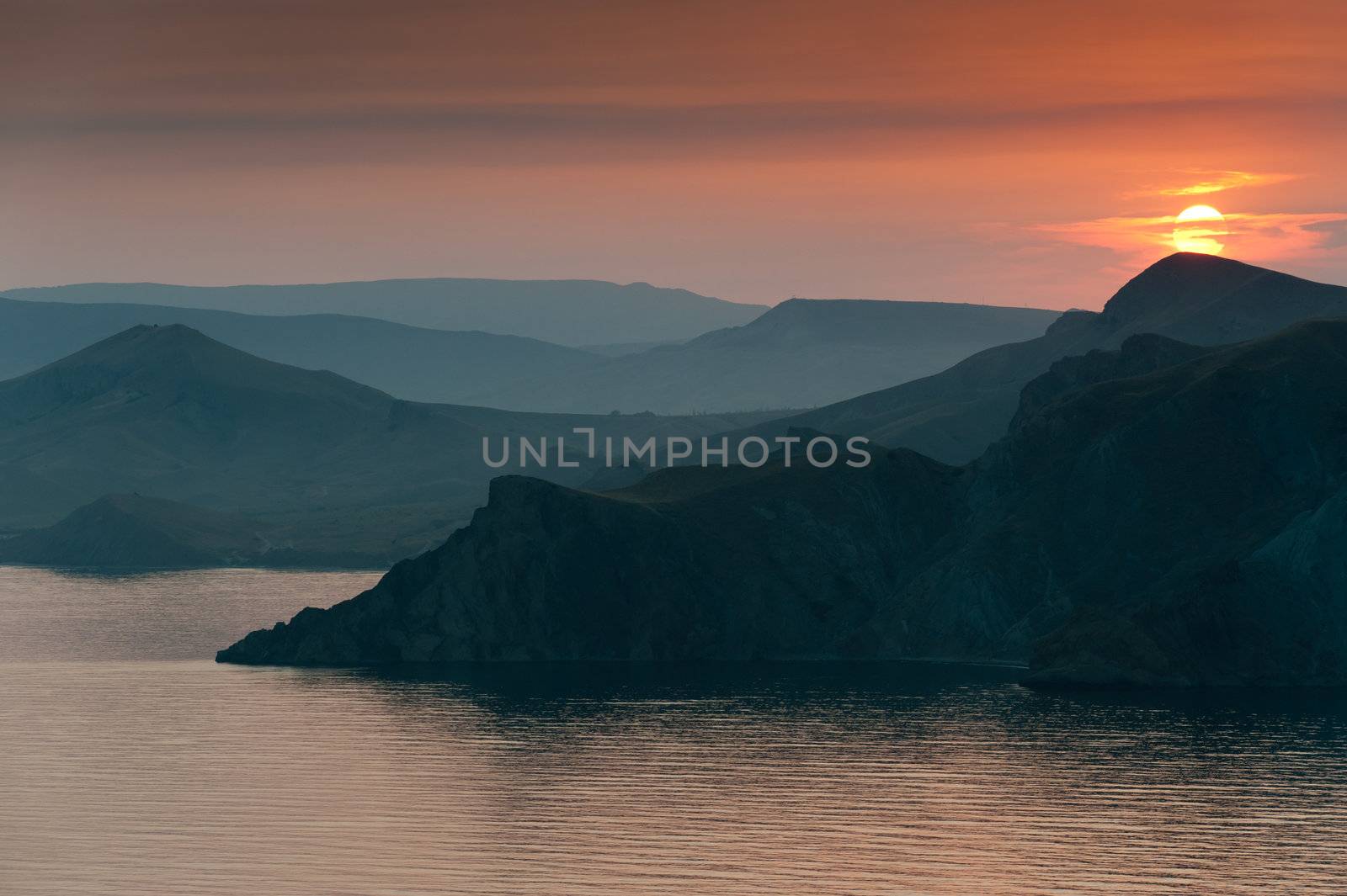 Colourful decline over mountains and the sea.