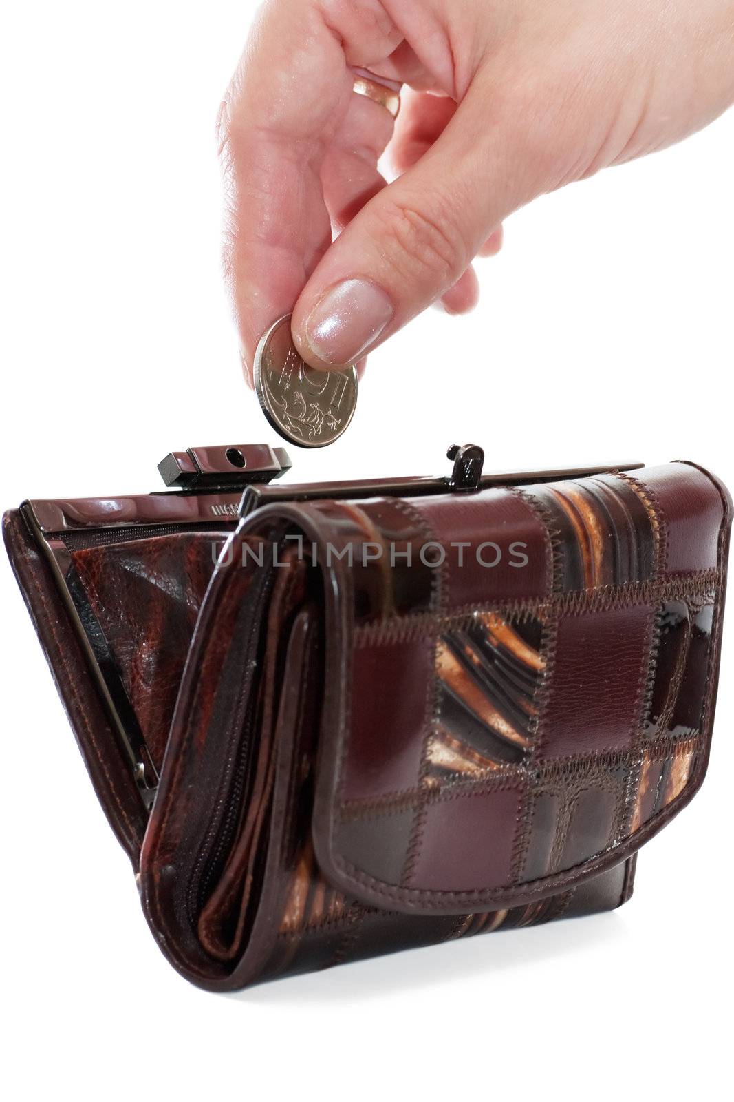 A female hand put into purse a coin isolated over white background