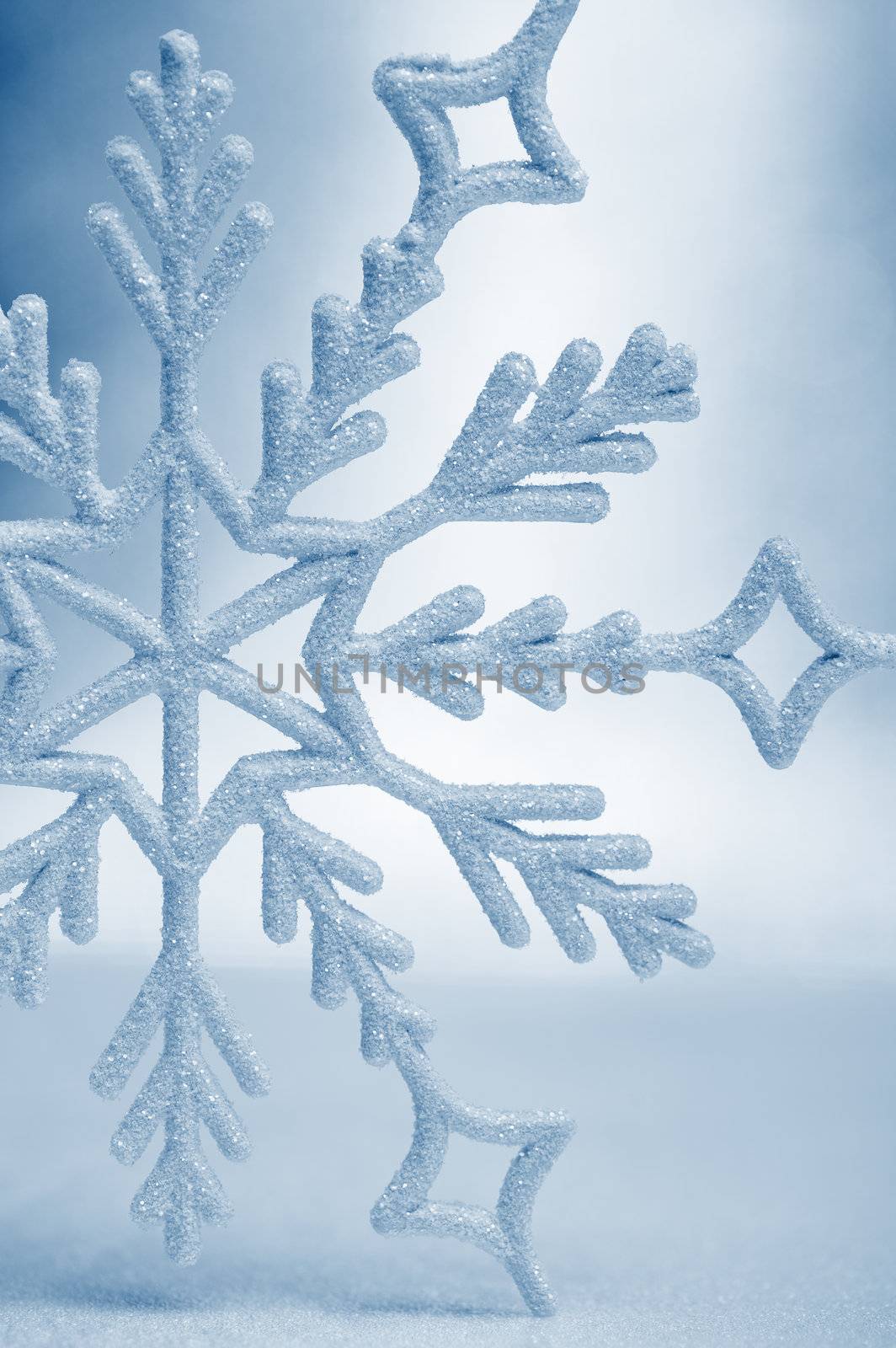 Snowflake big closeup. Bokeh a background. Toning is blue