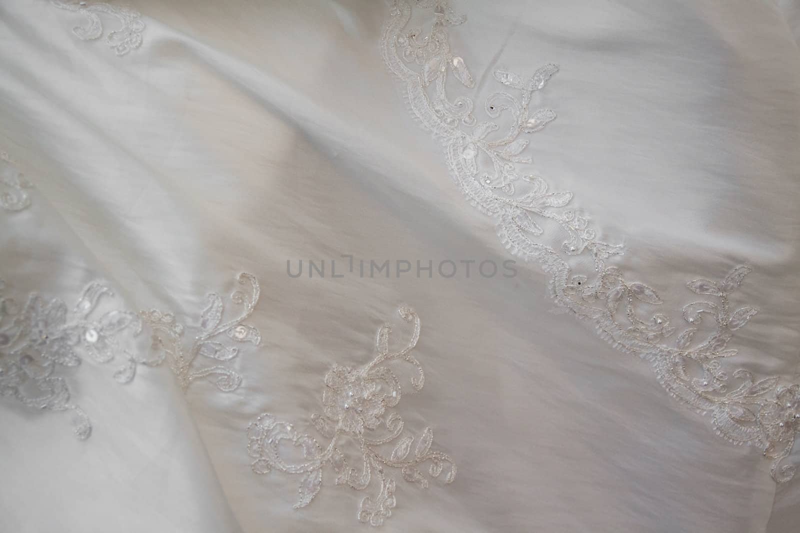 macro shot of white dress of bride