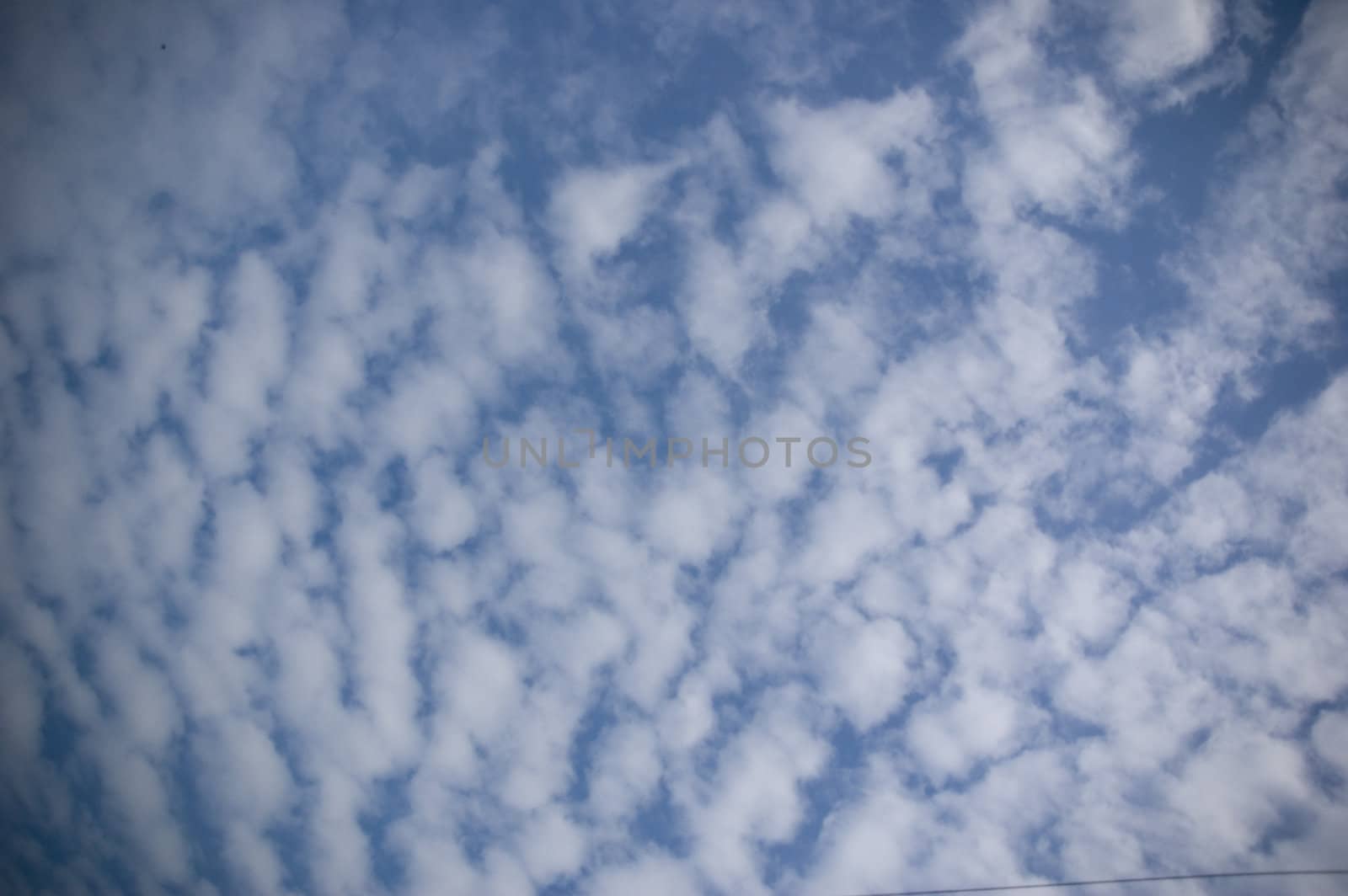 white cirrocumulus clouds on beautiful blue sky