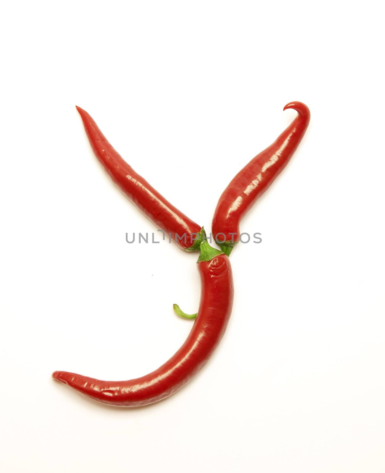Letter made from red peppers over white backround