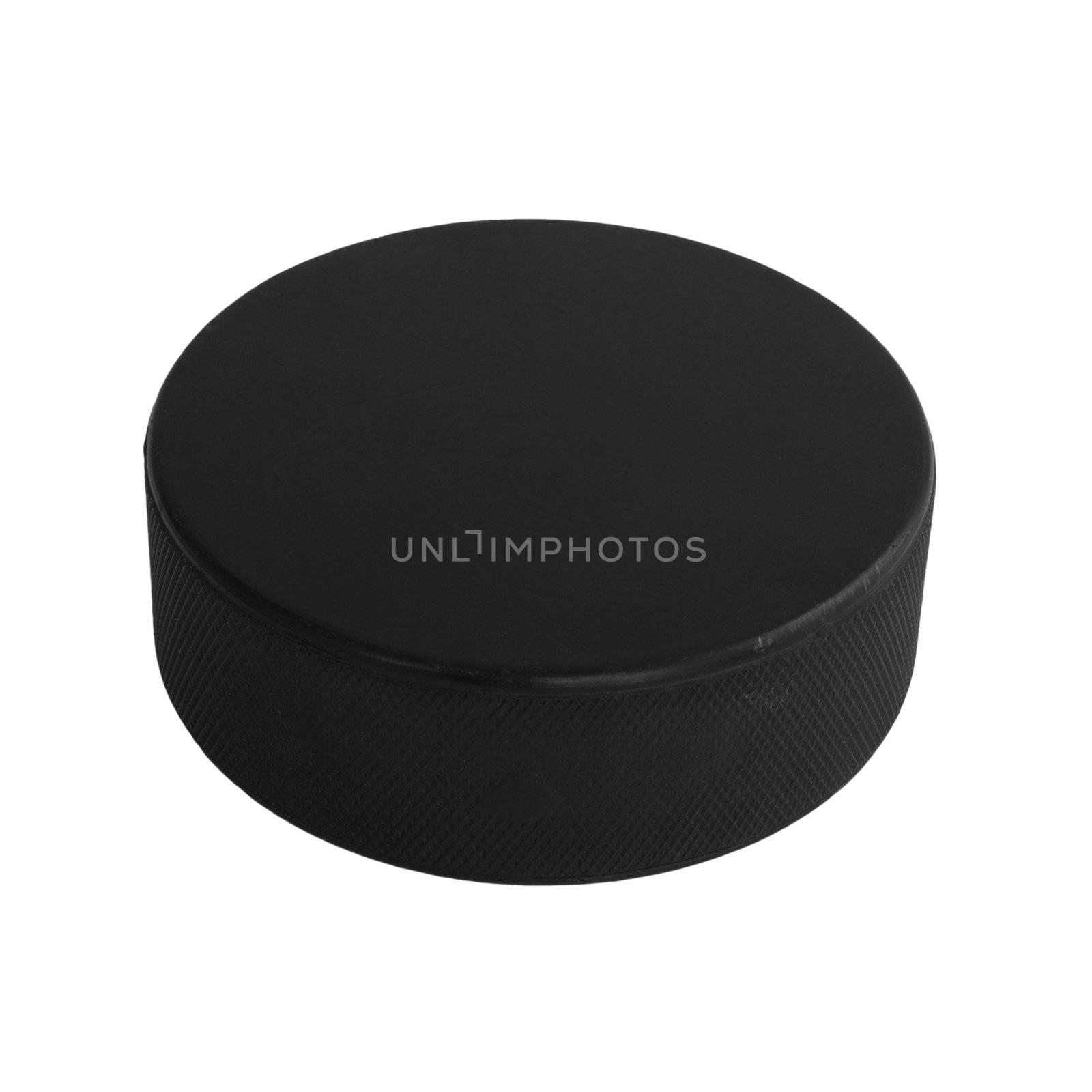 An isolated hockey puck laying flat over a white background.