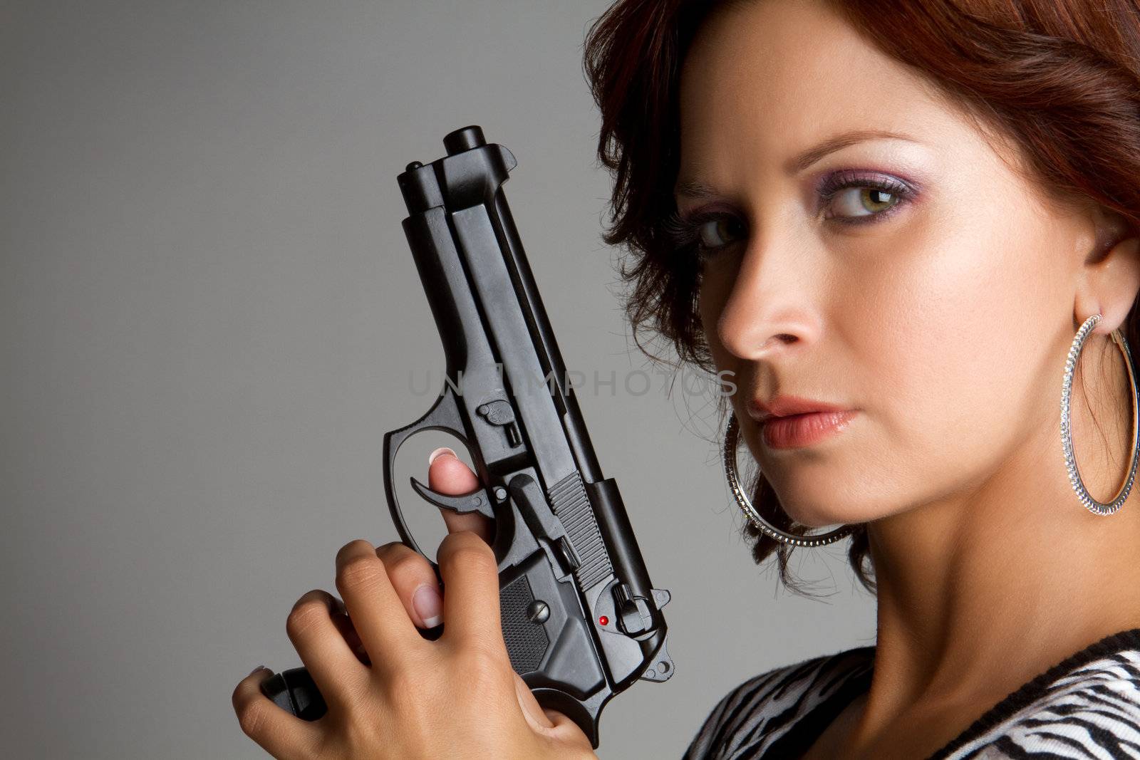 Sexy woman holding hand gun