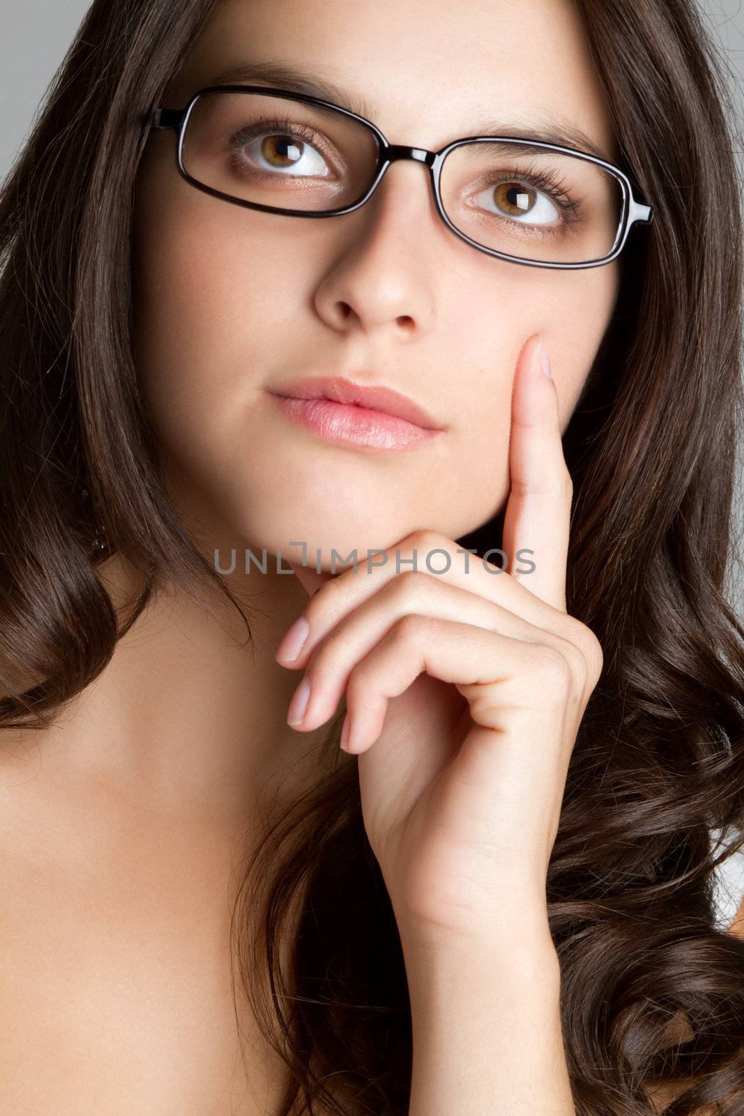 Beautiful thinking woman wearing glasses