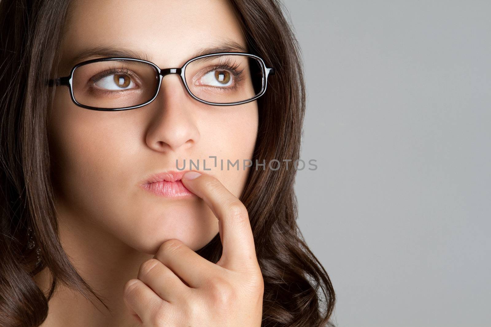 Thinking woman wearing eyeglasses