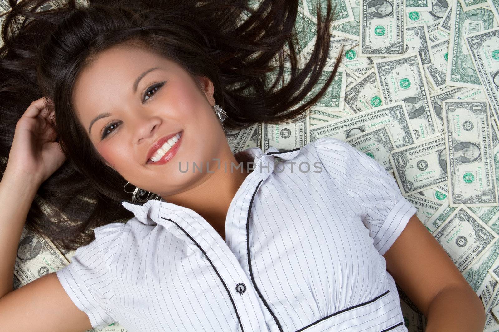 Asian woman laying in money