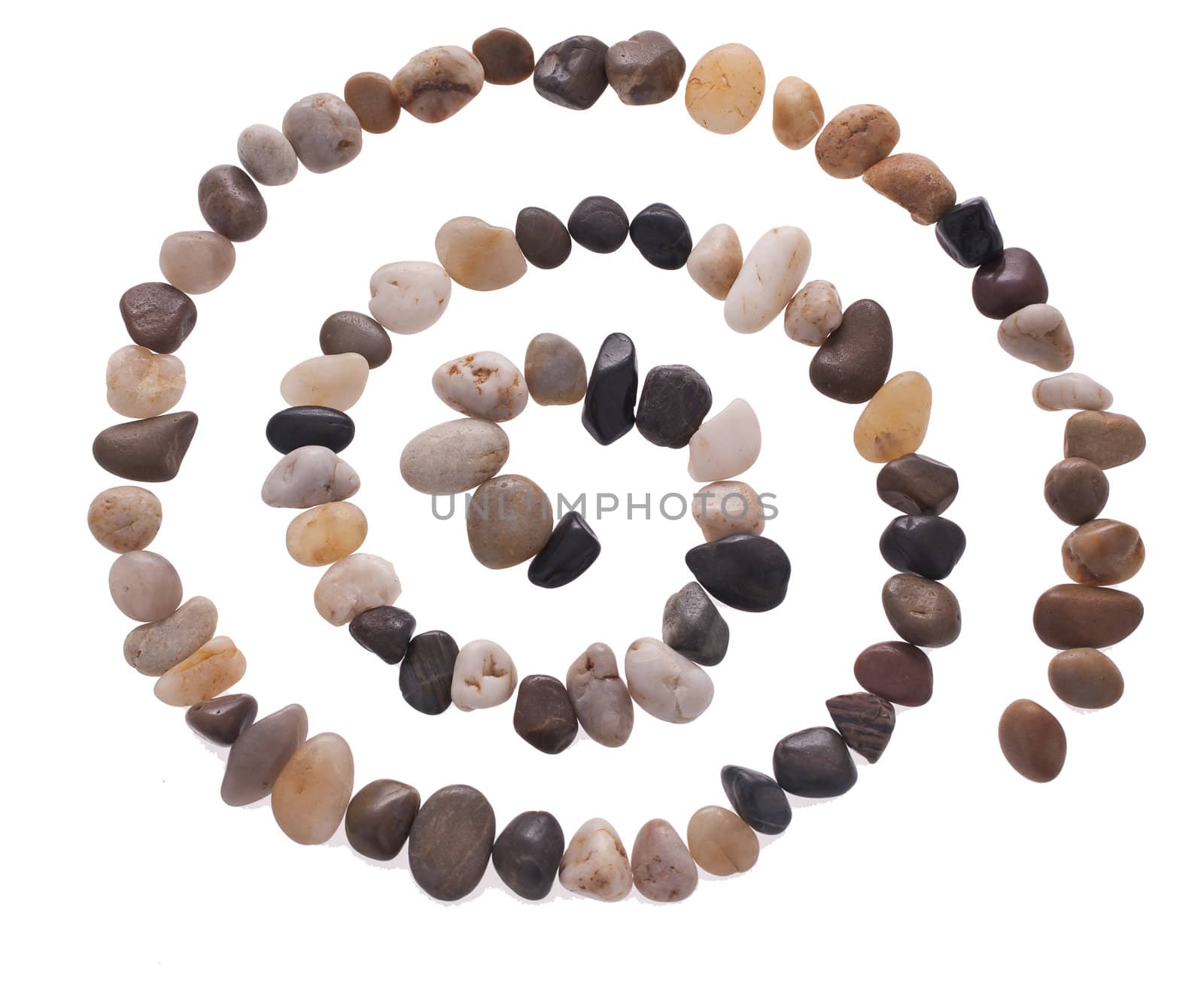 Stone spiral made from the beach pebbles isolated on the white