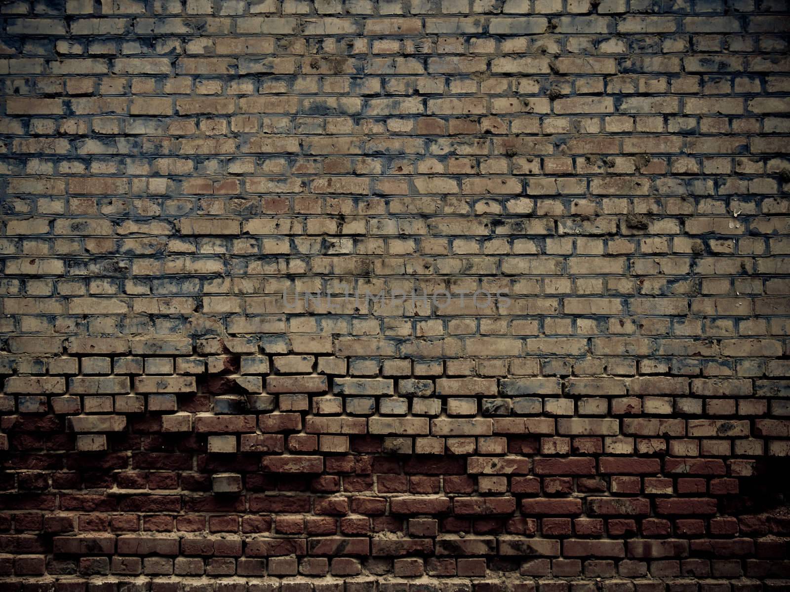 Old grunge crumbling brick wall