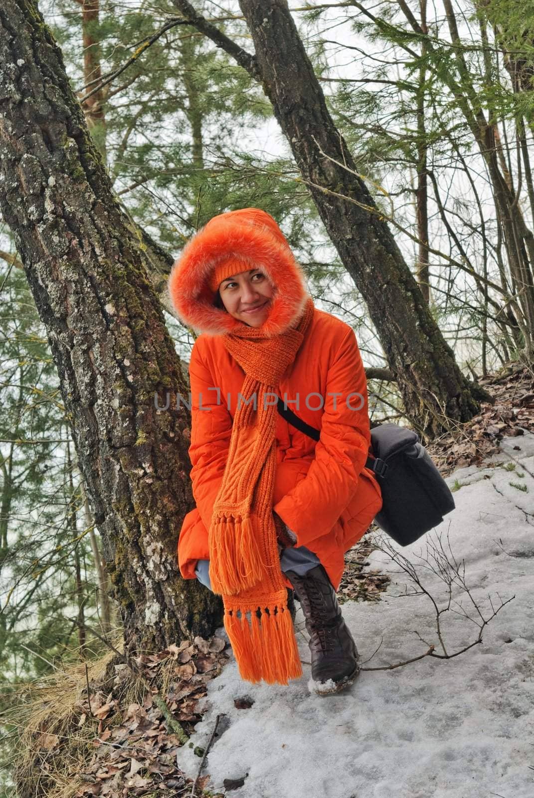 The girl in  orange coat on the  lake coast by photoka