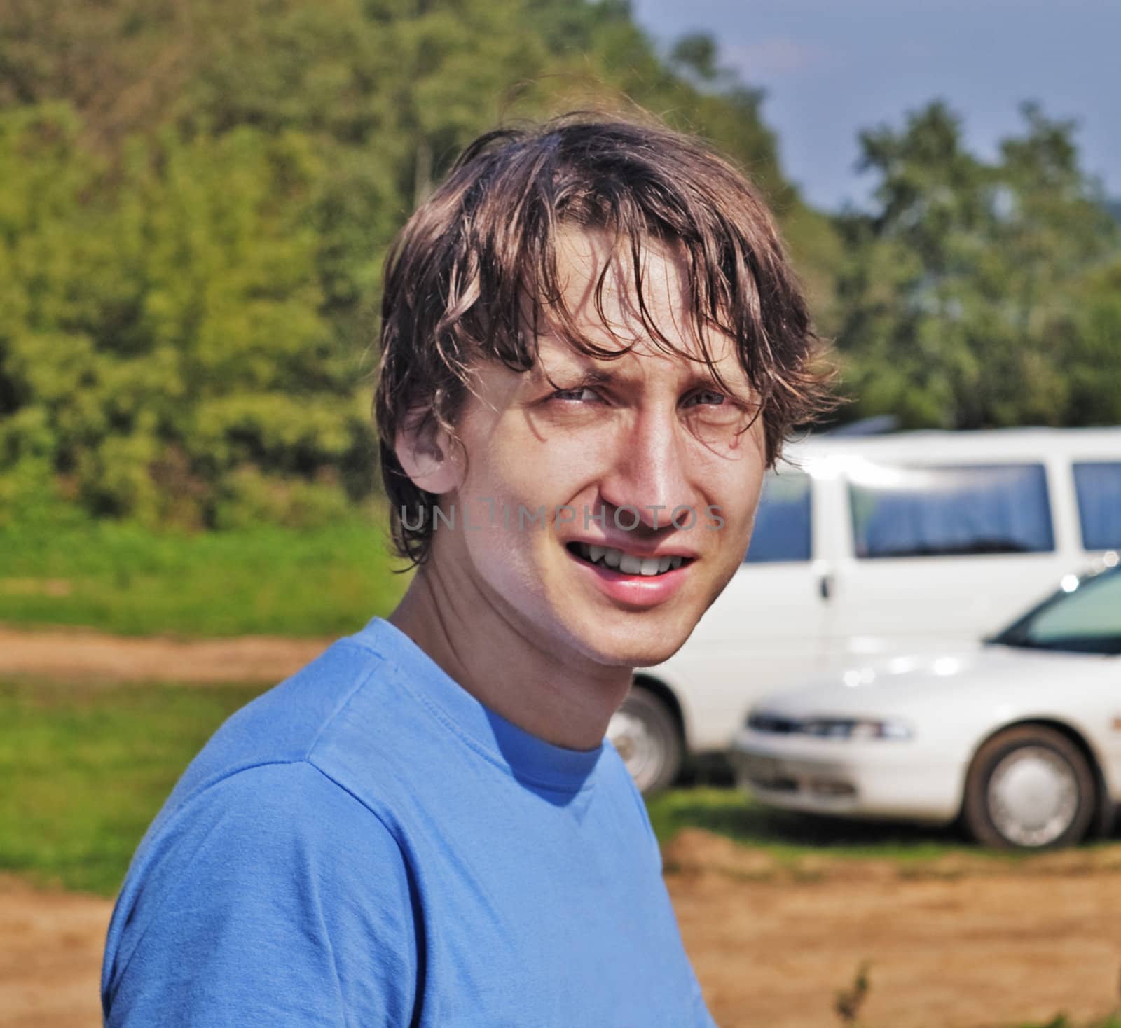 Portrait of the young guy on wood road