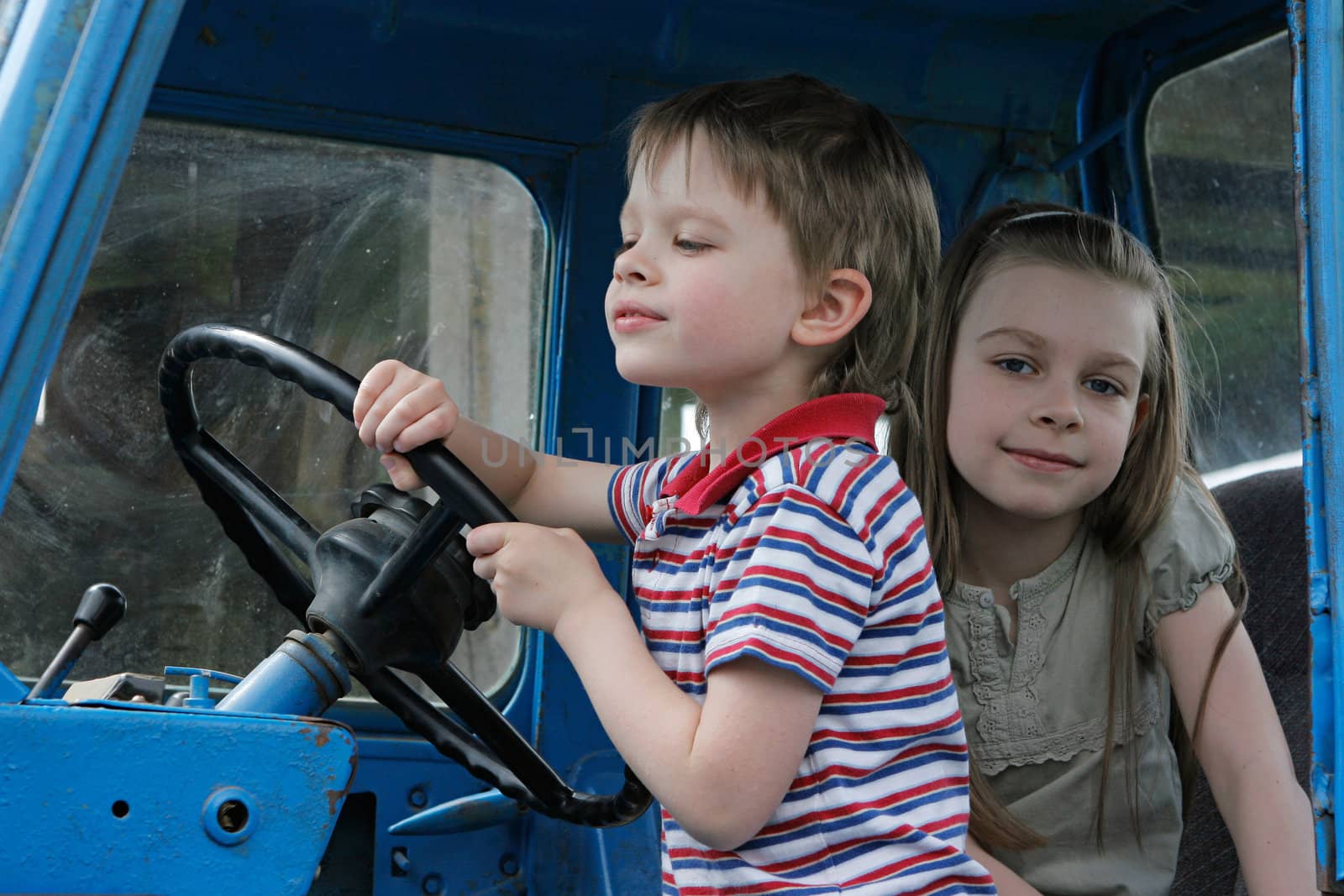 Brother and sister first time in tractor cab.