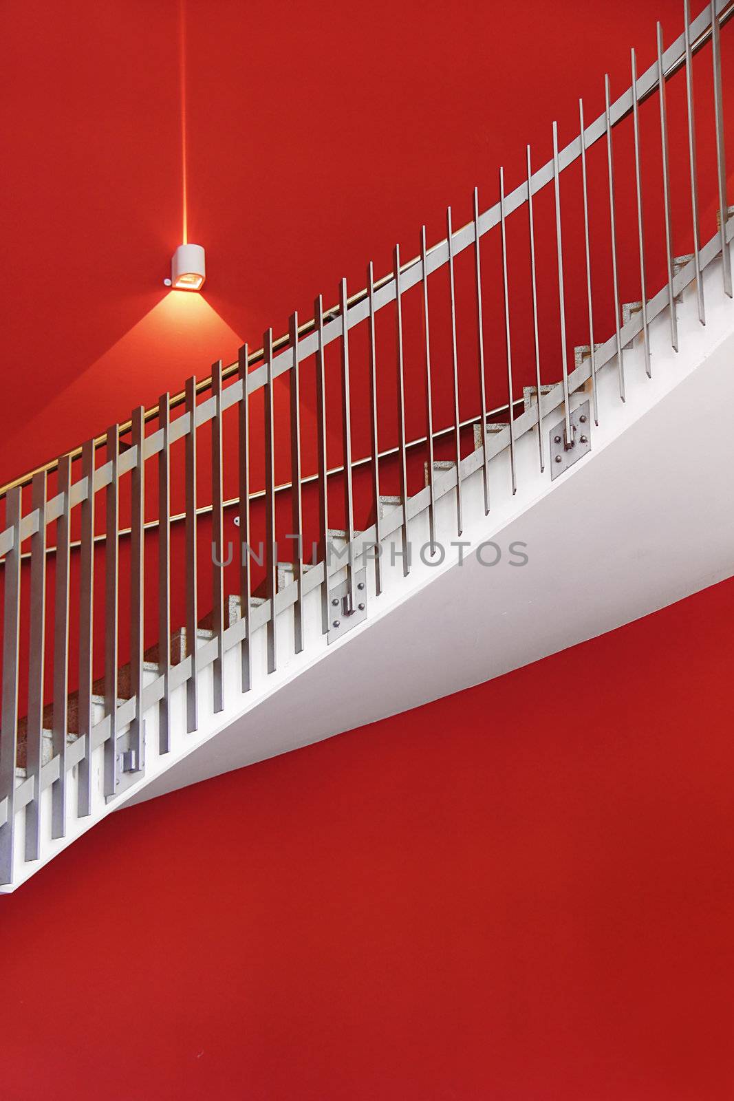 white stair with red wall and one light