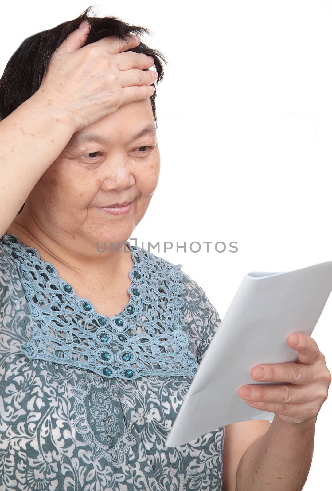 Closeup portrait of smiling senior woman reading a book  by cozyta