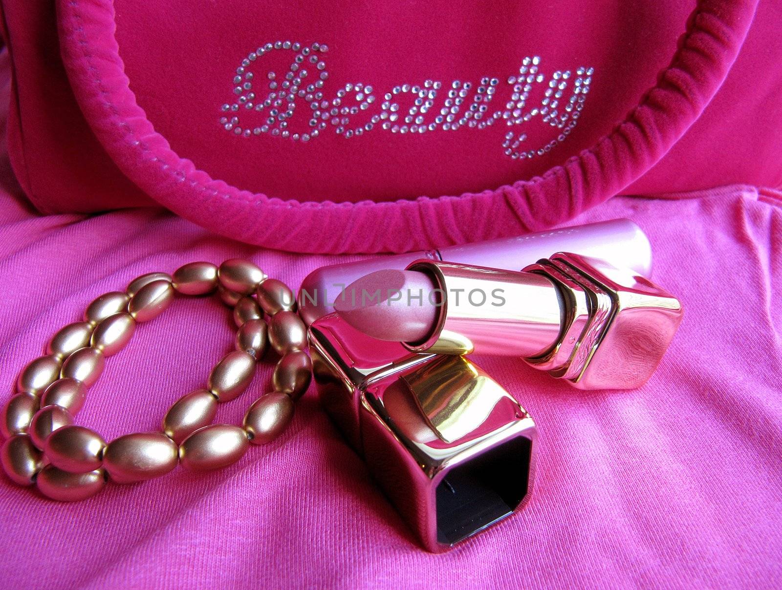 A lipstick, perfume vaporizer, two fashion bracelets and a pink cosmetics bag in gold and pink.