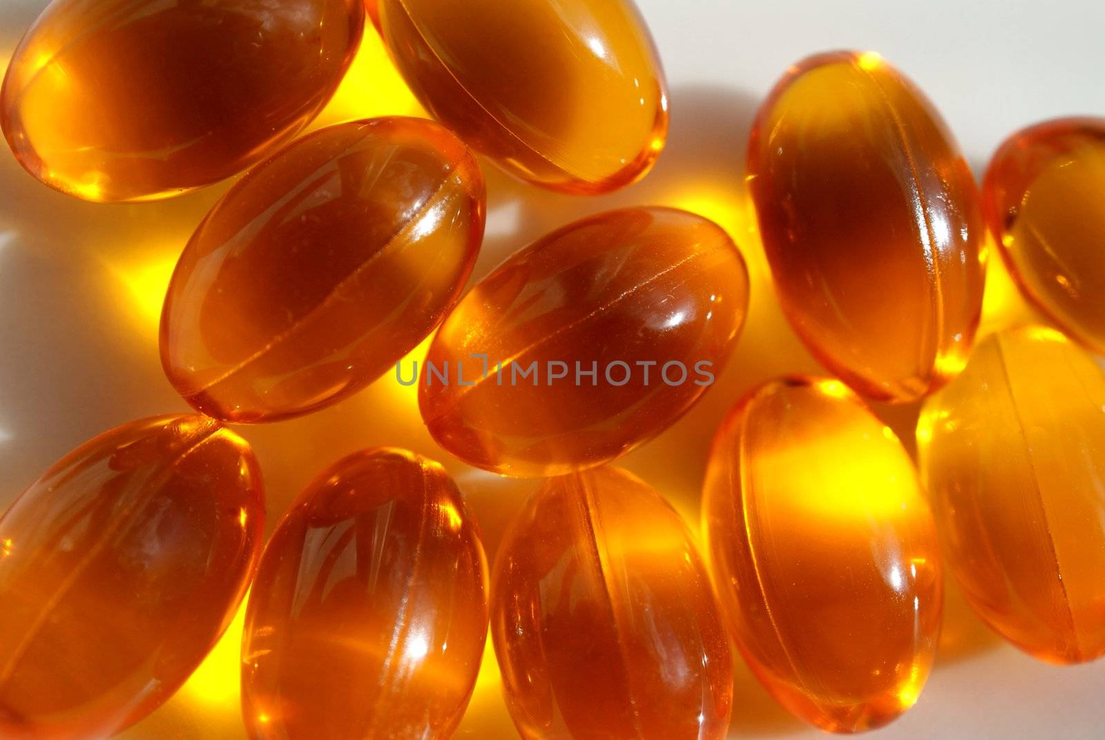 Eleven Multi Omega capsules photographed close up. Capsules contain Omega 3, 6, 7 and 9 fatty acids. 