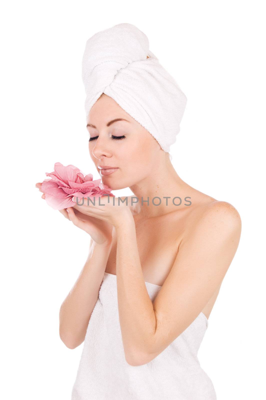 Woman after bath with towel and flower isolated on white