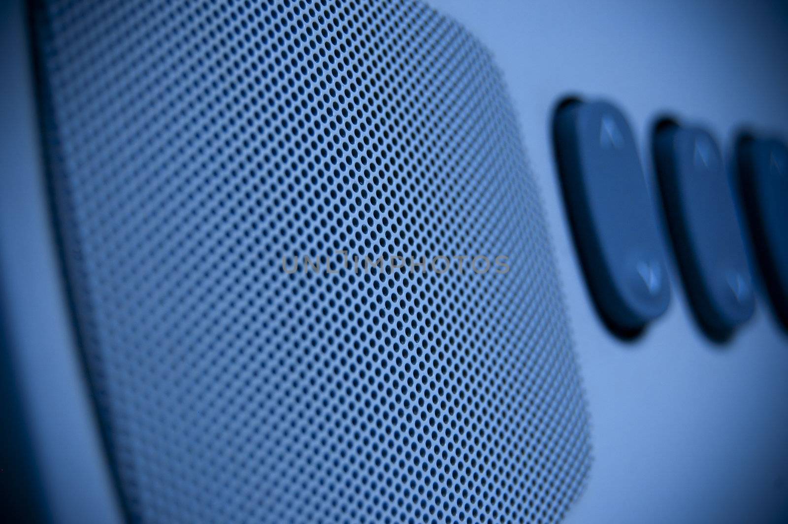 A blue loudspeaker with some key in background