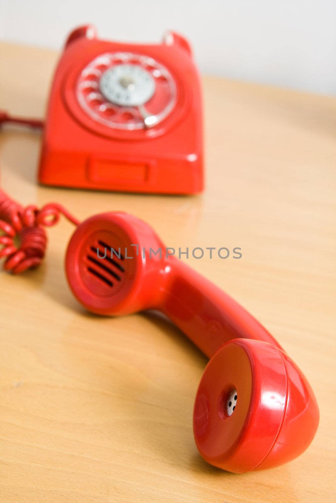 Vintage red telephone on wooden table